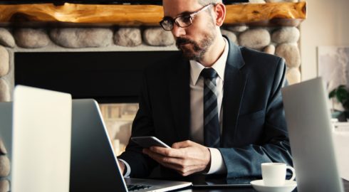 Man On a Computer Considering Investing in Commercial Property